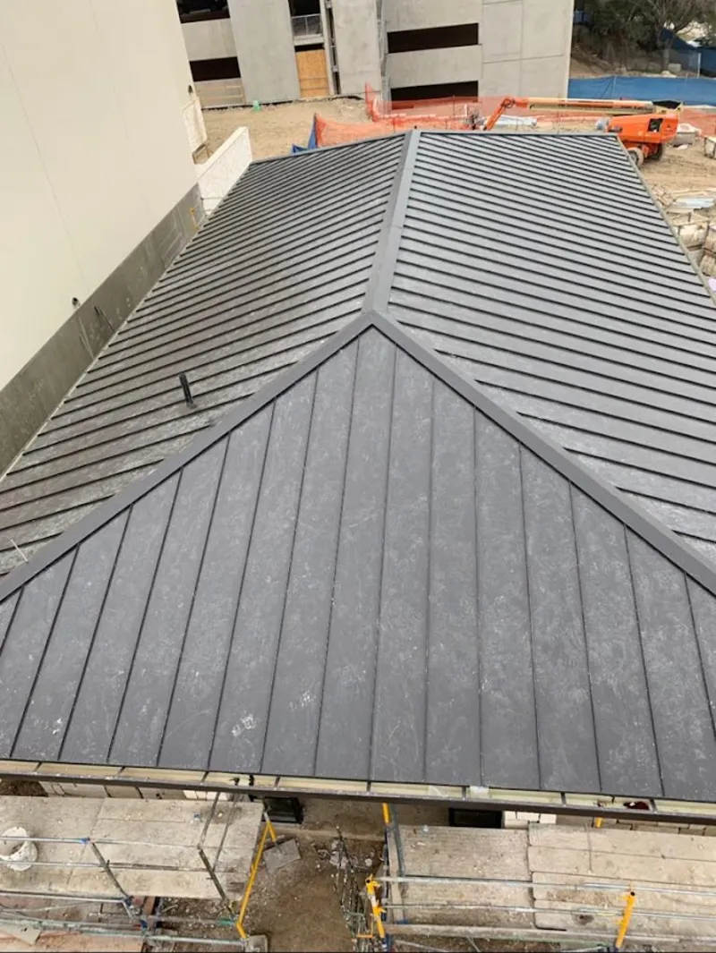 Commercial metal roof construction with crane equipment in Morristown