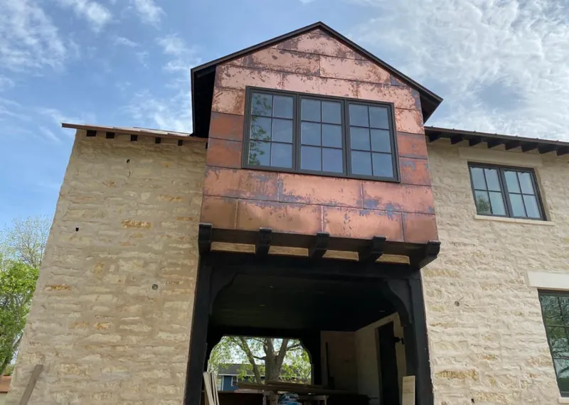 Copper metal panel facade on a stone building for Roof Repair in Morristown